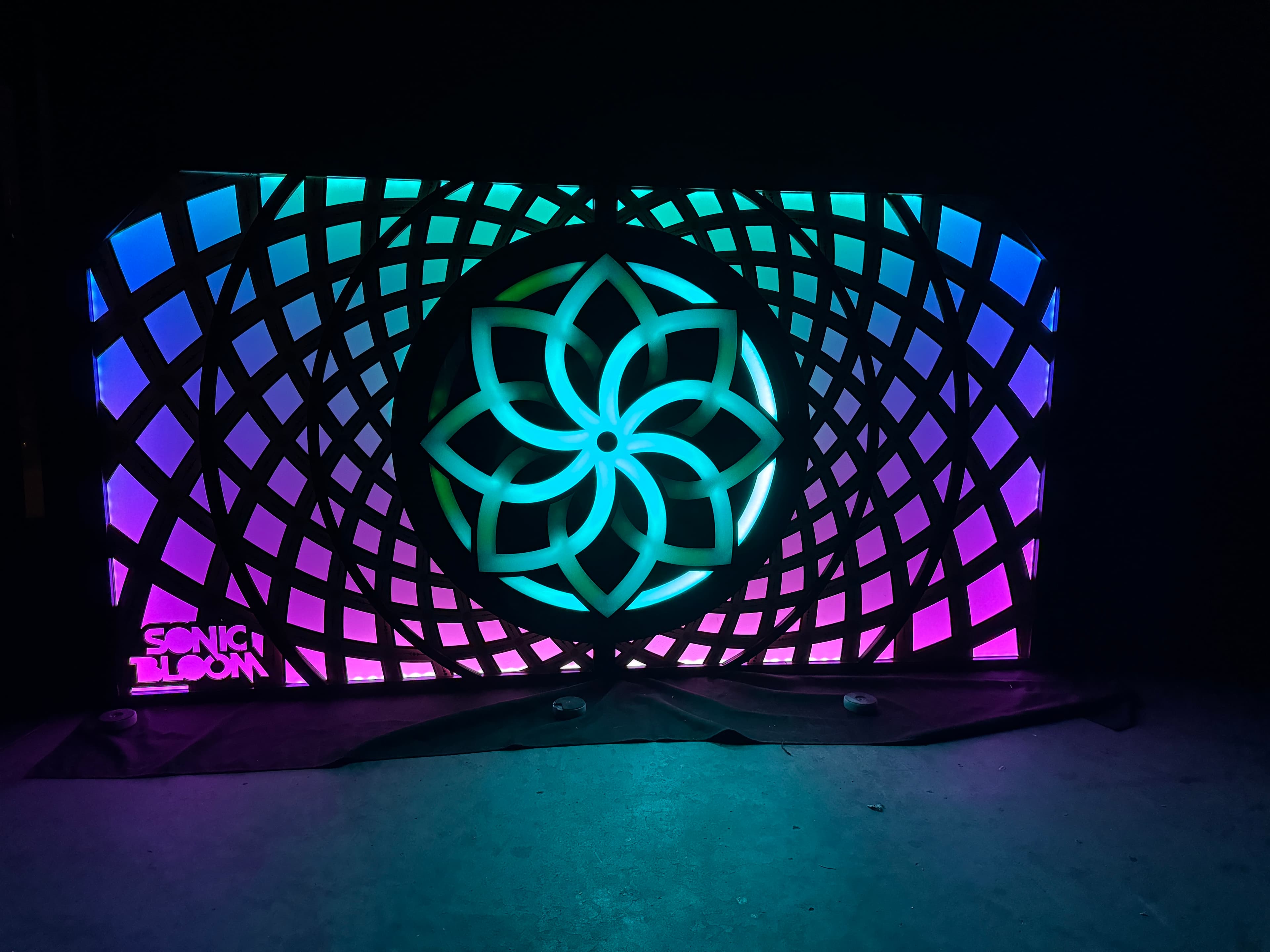 Sonic Bloom DJ booth — illuminated stage facade