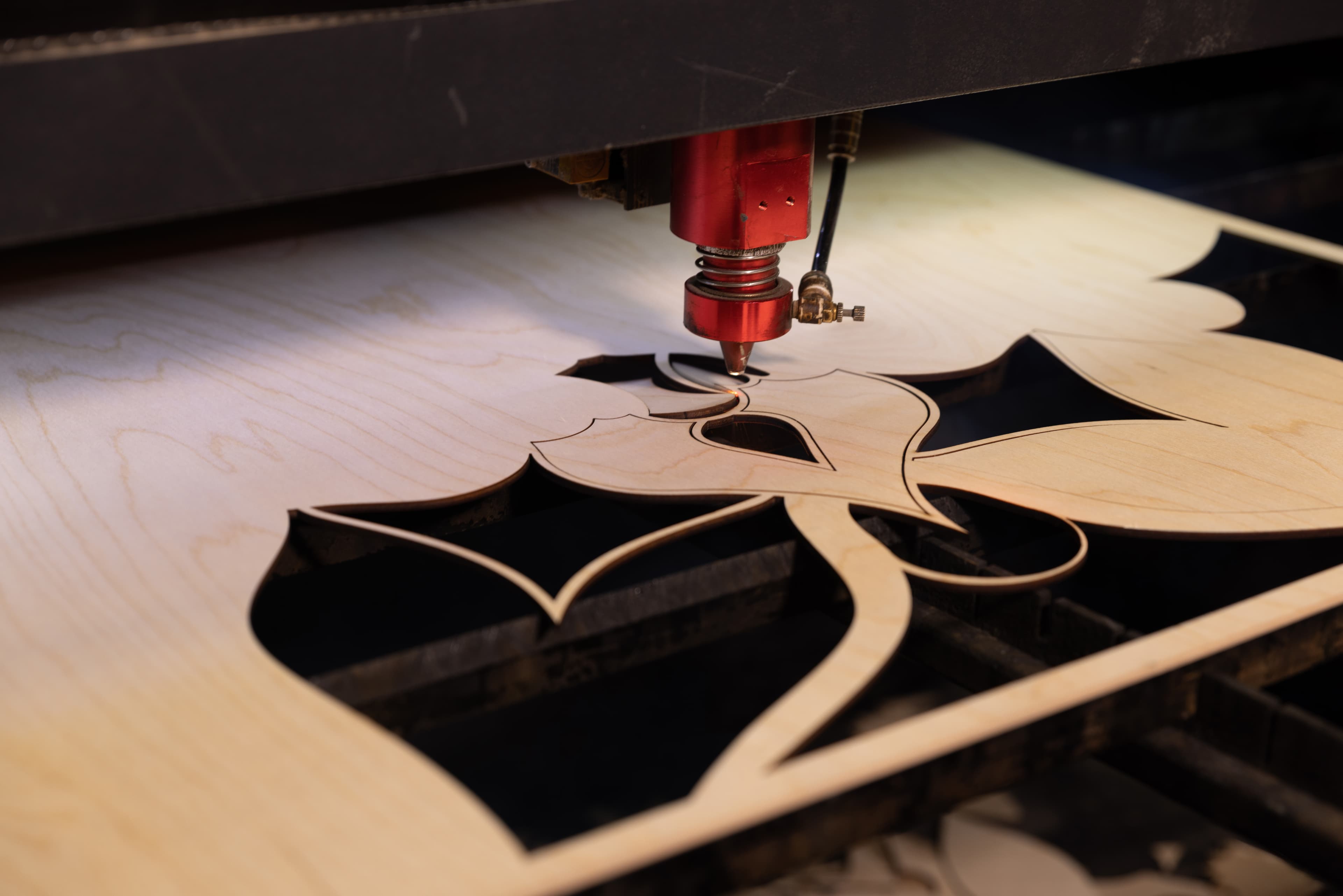 Laser head cutting intricate floral pattern